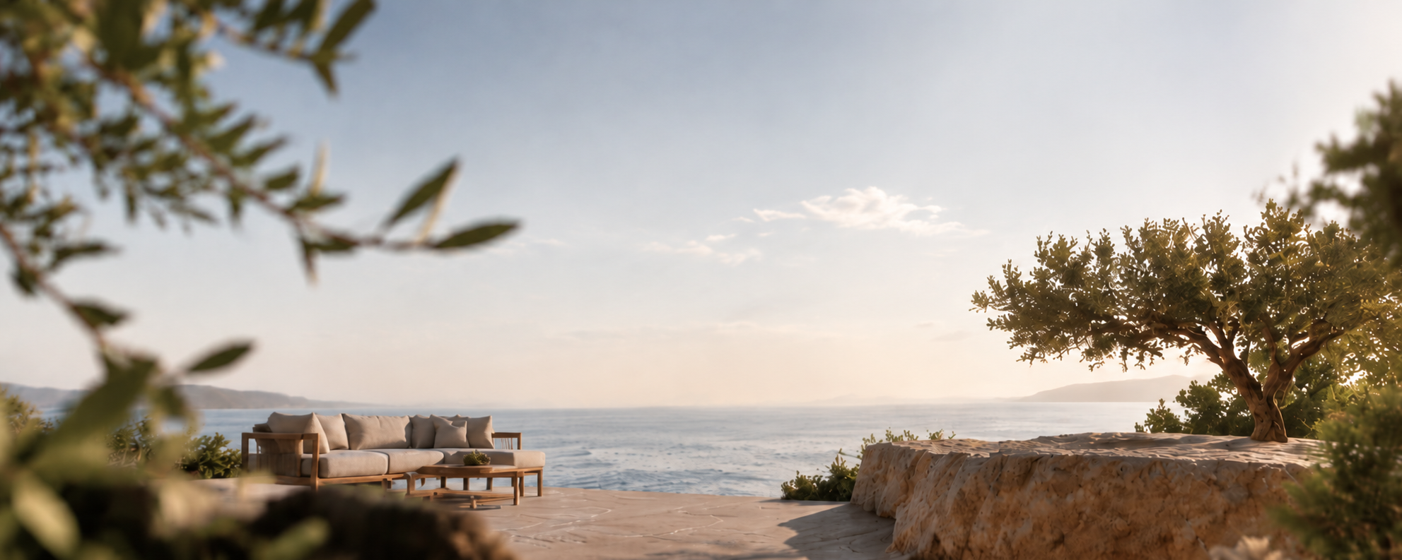 A sunlit outdoor terrace with teak furniture and linen textiles at golden hour
